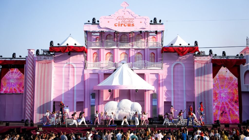 The pink main stage of the LMC with crowd beneath it