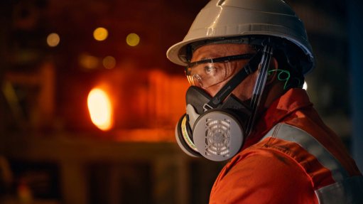 An image of a worker using a Dromex respirator