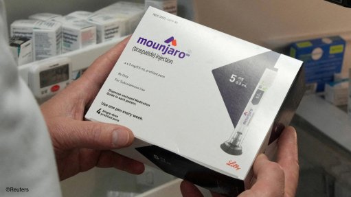 Pharmacist holding a box of Mounjaro