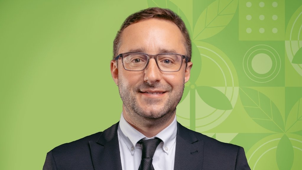 Pele Green Energy GM Nicolas Lecomte in suit and tie, green background