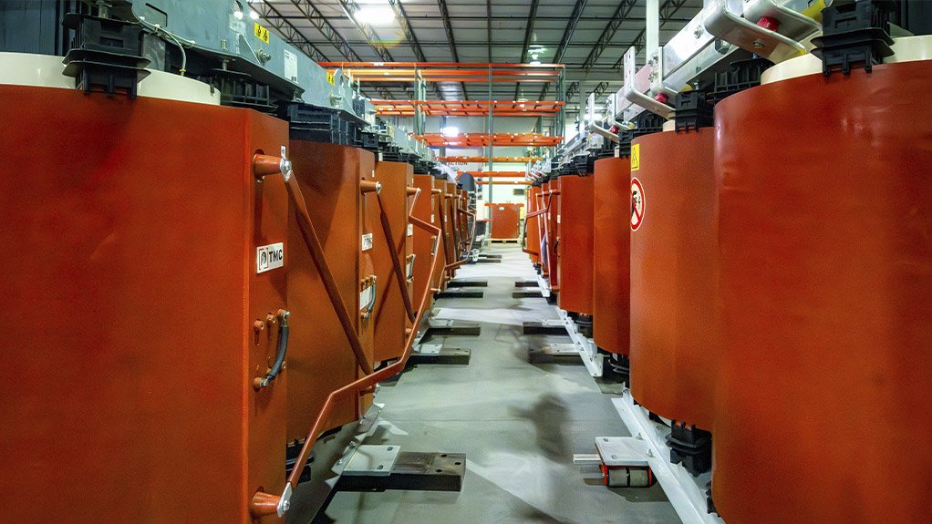 The TMC production plant features a row of precision-built cast resin transformers undergoing testing and final quality inspection