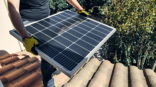 person carrying a solar panel