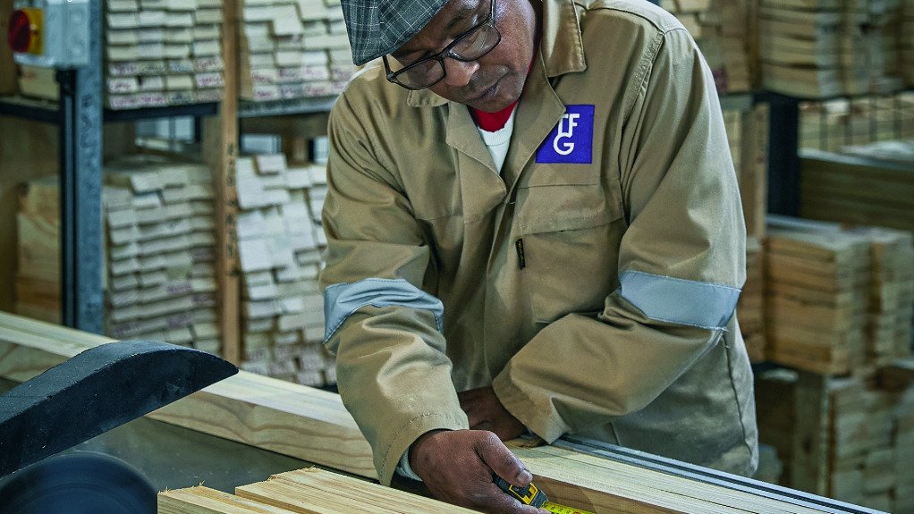 Furniture manufacturing worker working with timber