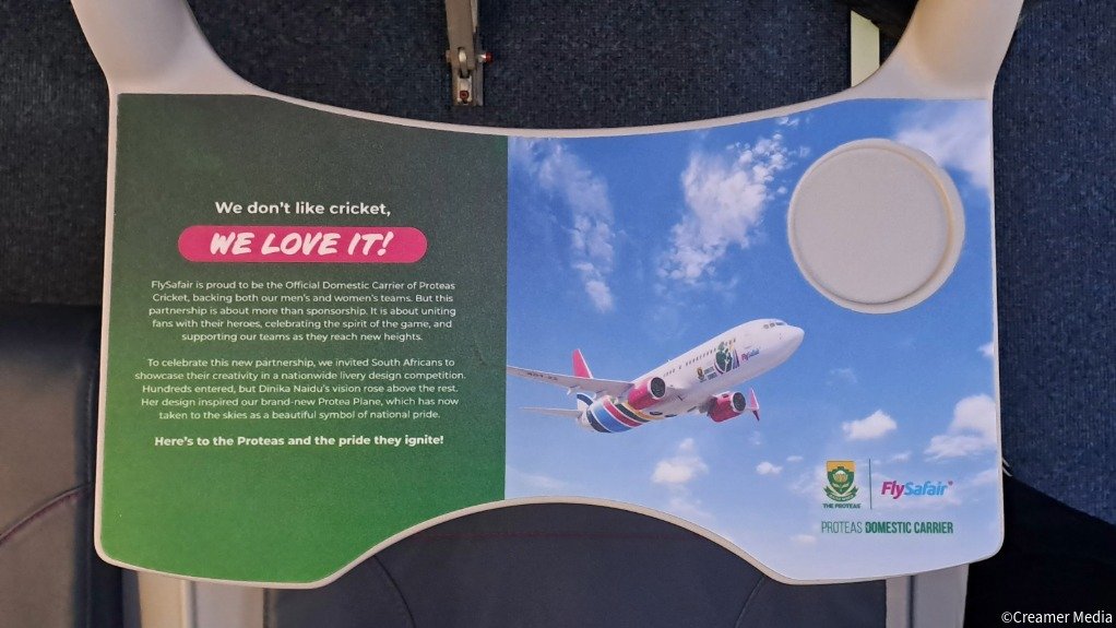 An image of the tray table inside the FlySafair Protea-branded 