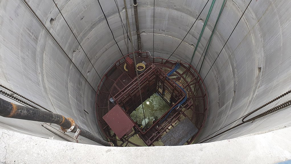 A pre-sink stage in a concrete-lined shaft with services erected, illustrating the structured approach that safeguards workers as infrastructure is progressively installed