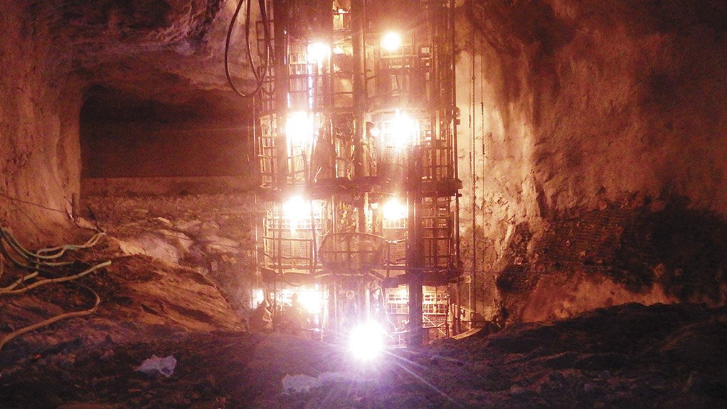 A sinking stage is shown passing an excavated station underground, with engineered systems in place to ensure stability and the safety of crews at depth