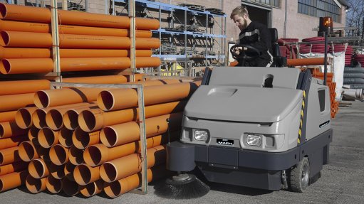 Image of a floor cleaning machine cleaning the outside of a factory