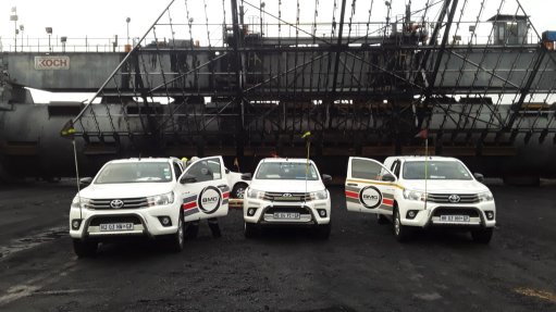 Three BMG service vehicles parked in front of a mining operation