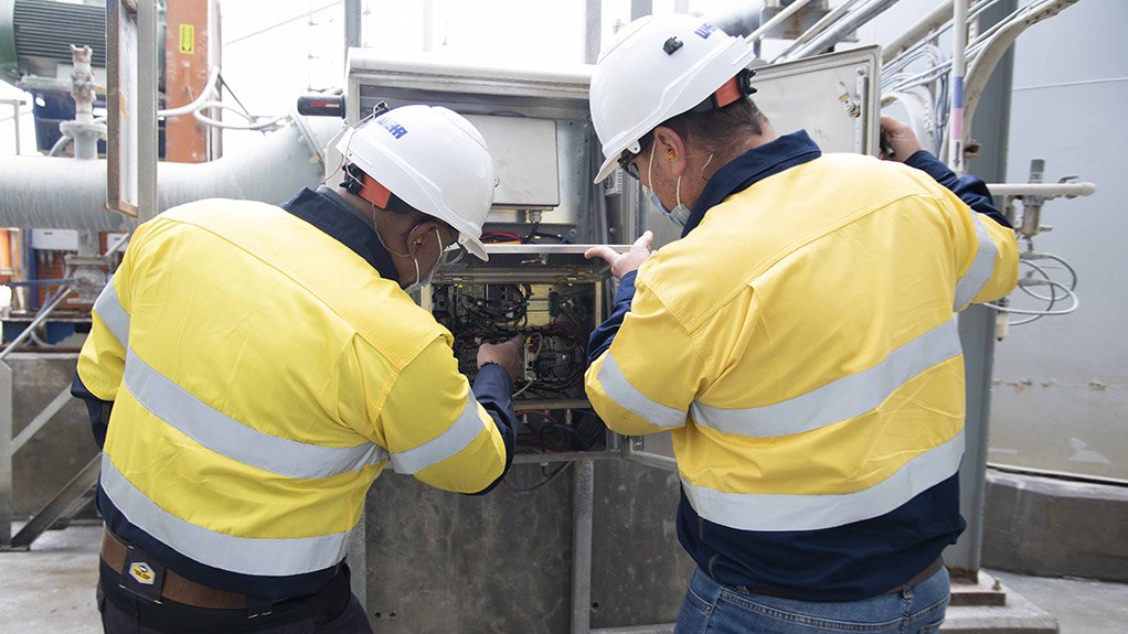 Image of Weir technicians implementing precise adjustments on physical equipment