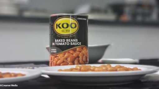 A can and plates of Koo baked beans