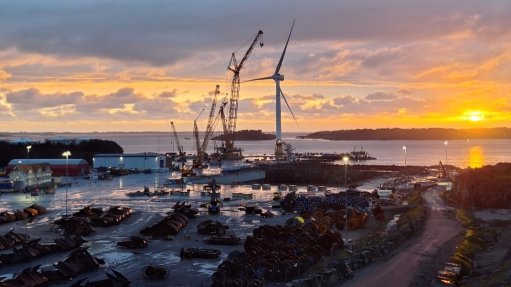 A wind turbine and crane at port
