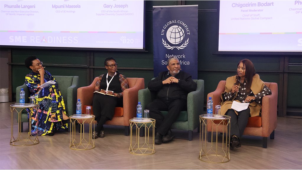 Image of a panel of speakers on a stage at a GCNSA event at the B20