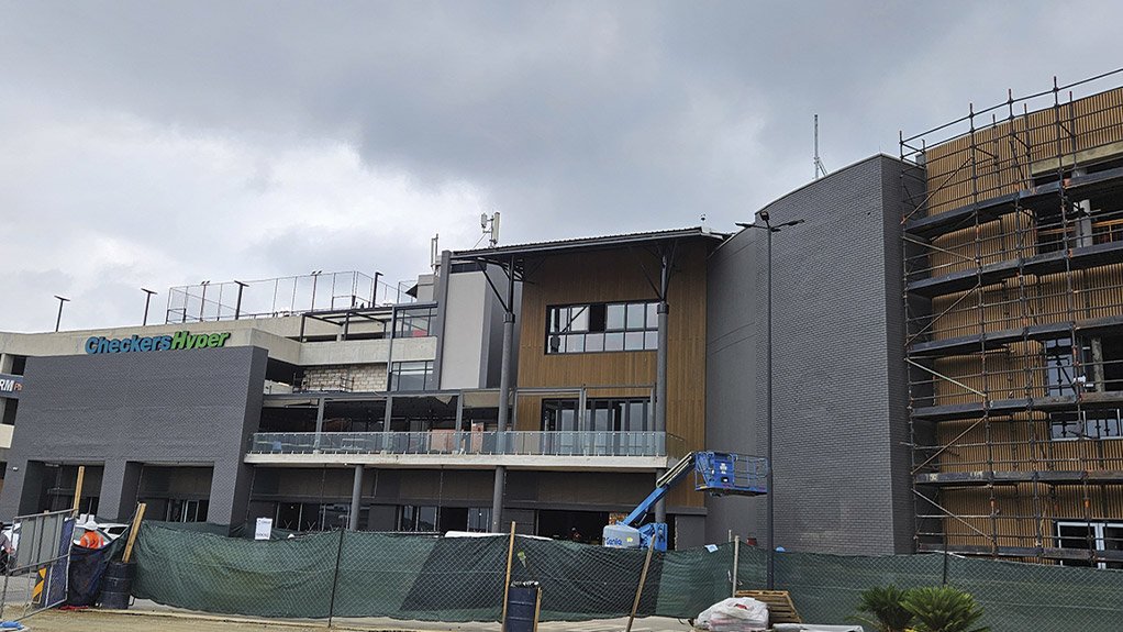 Façade cladding in progress at Concor’s The View project at Fourways Mall, using recycled timber materials for a sustainable finish
