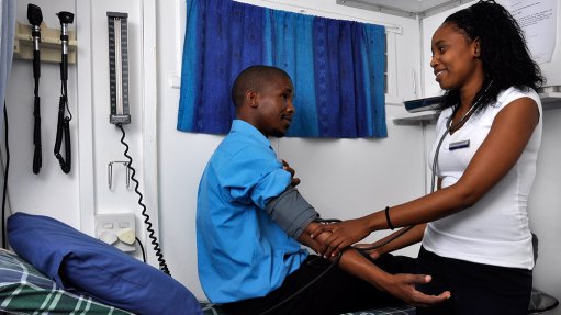 An image of a healthcare practitioner assisting a patient