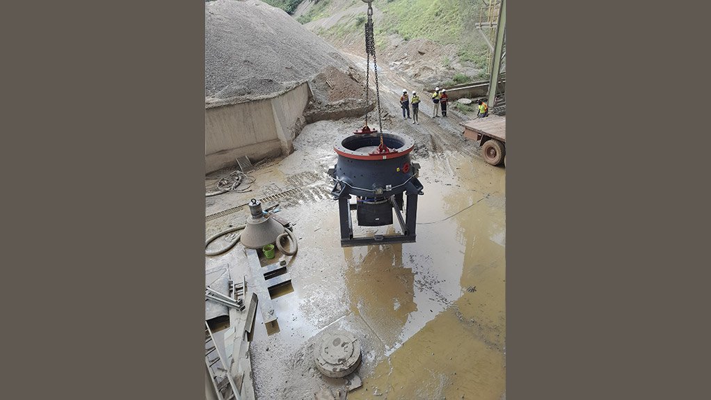 The bottom shell of the new Sandvik CH851i cone crusher supplied by Sandvik Rock Processing being offloaded from its stand and lowered to the ground