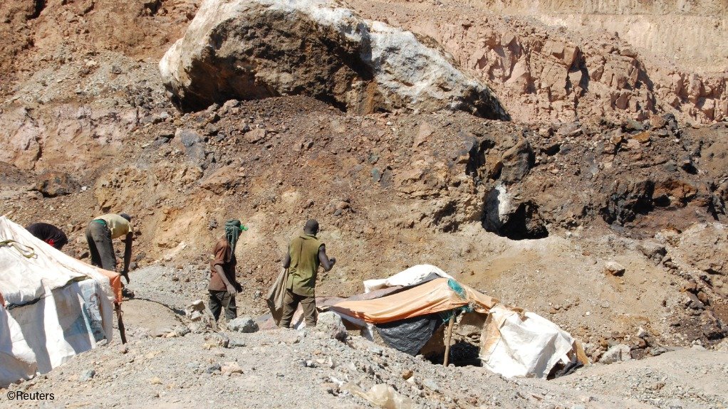 Artisanal miners work at the Tilwizembe, a former industrial copper-cobalt mine, outside of Kolwezi, in the DRC