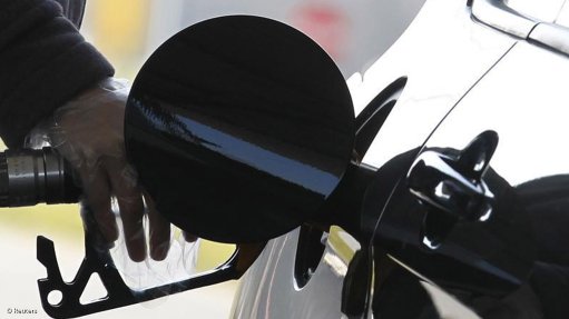 Person filling a car with fuel