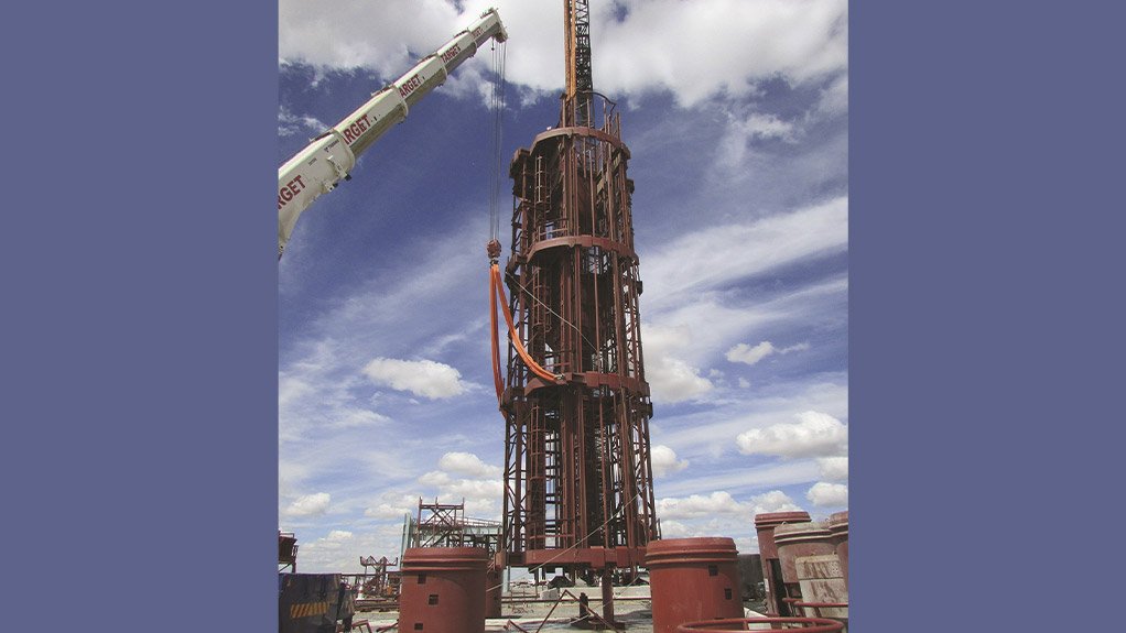 Cementation Africa demonstrates a specialist shaft sinking capability through the installation of a three deck stage into the pre-sink section of a shaft, carried out using heavy and tandem lifts by its in-house rigging and roping team
