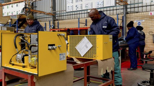Image of technicians in a workshop testing cab climate control units 