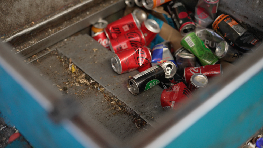 An image of metal cans being processed for recycling
