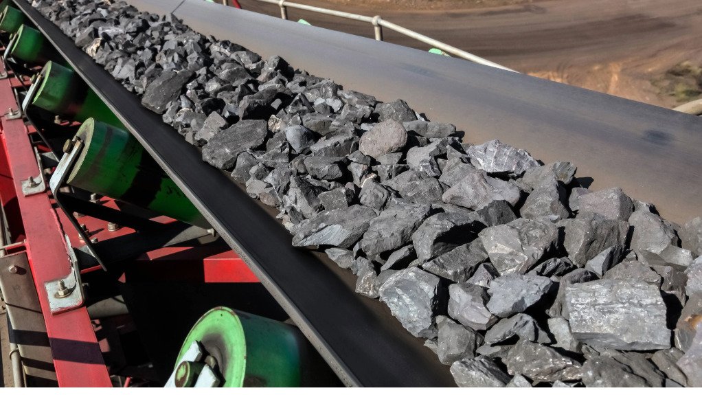 Manganese ore being transported via conveyor