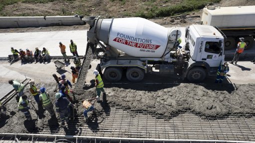 Image of a cement mixer at a road construction site