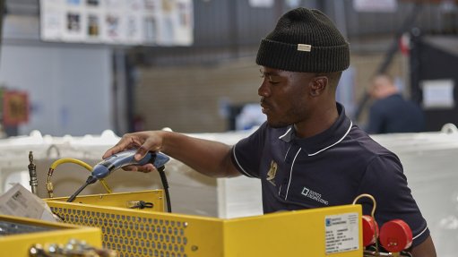 Image of a technician assembling a Booyco Engineering underground HVAC unit