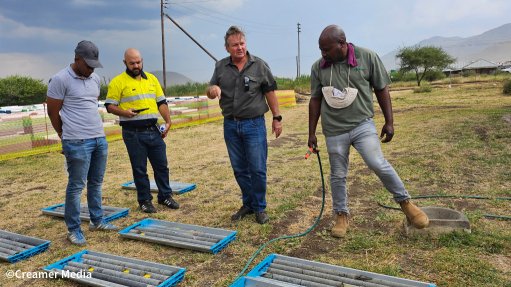 An image of Minxcon exploration director Uwe Engelmann exploration director Uwe Engelmann explaining samples