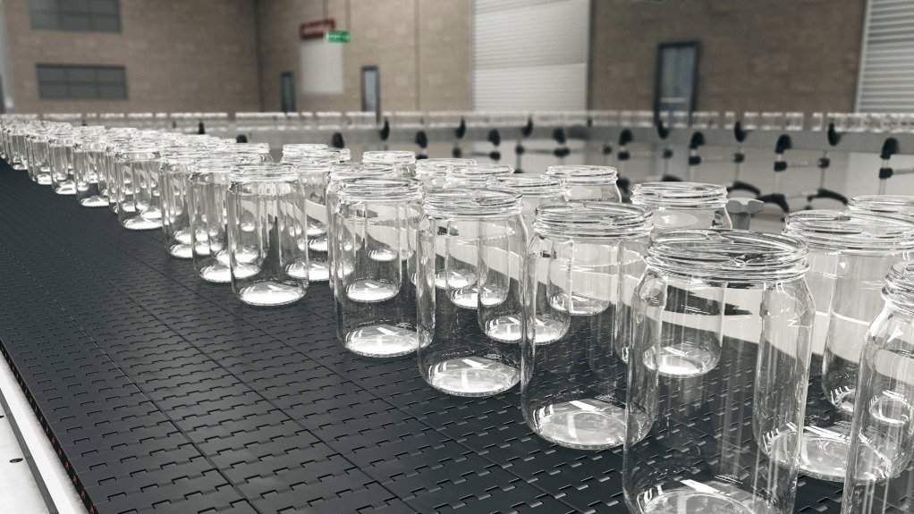 The above image depicts glass containers on a conveyor