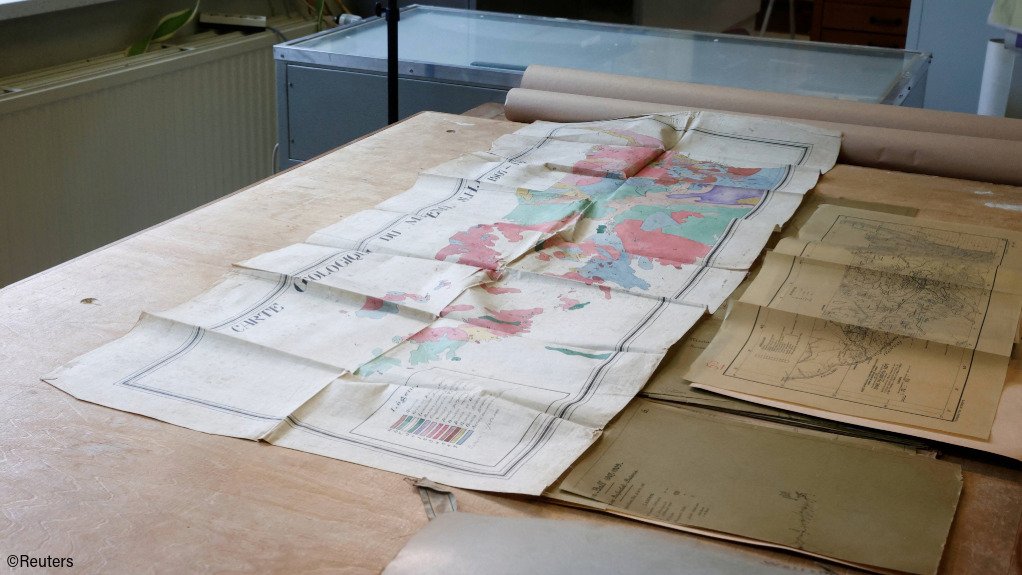 Maps of the DRC spread out on a desk