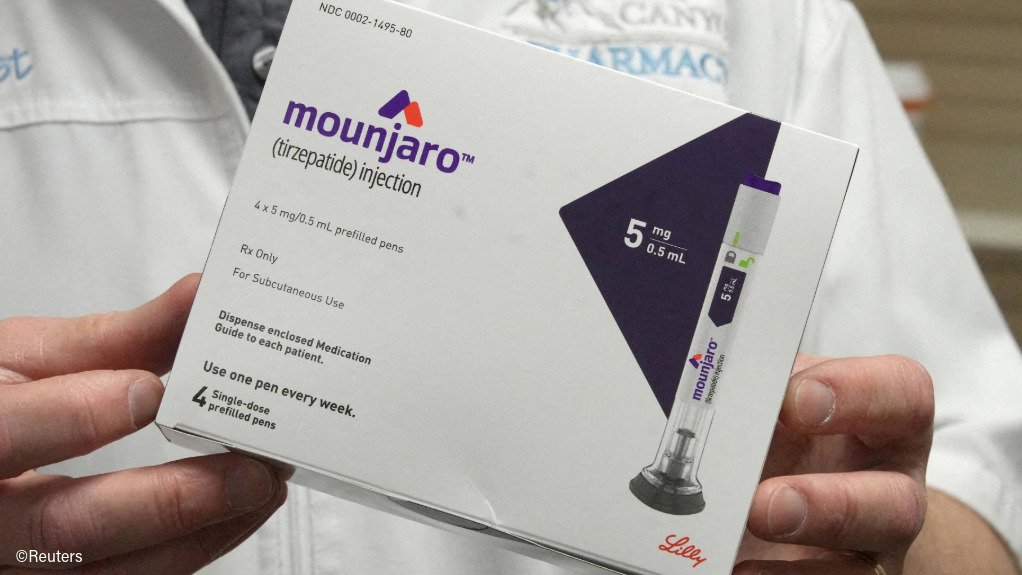 Hands holding a box of Mounjaro