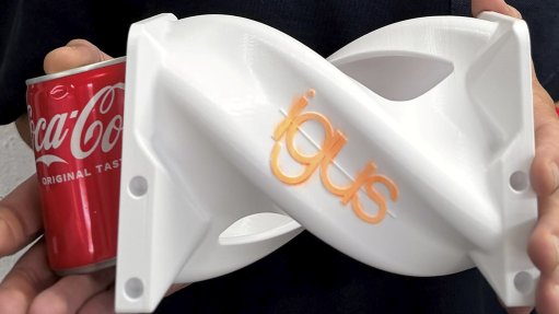 Image shows 3D printed igus can turner and an aluminium cooldrink can