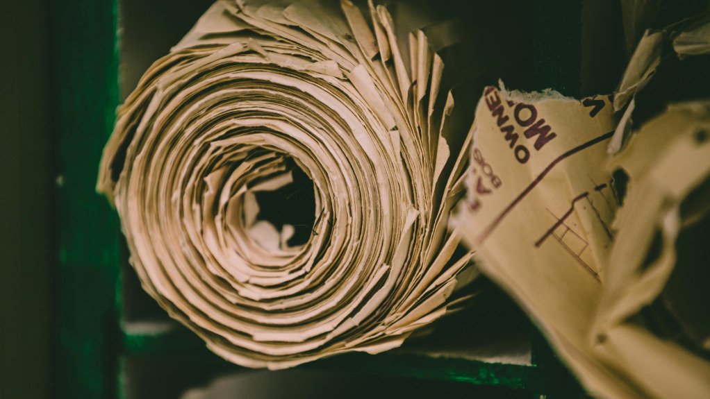 A coiled roll of brown branded paper