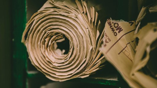 A coiled roll of brown branded paper