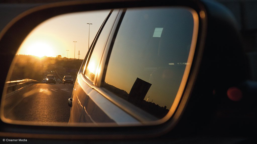 Traffic seen in the side mirror of a car