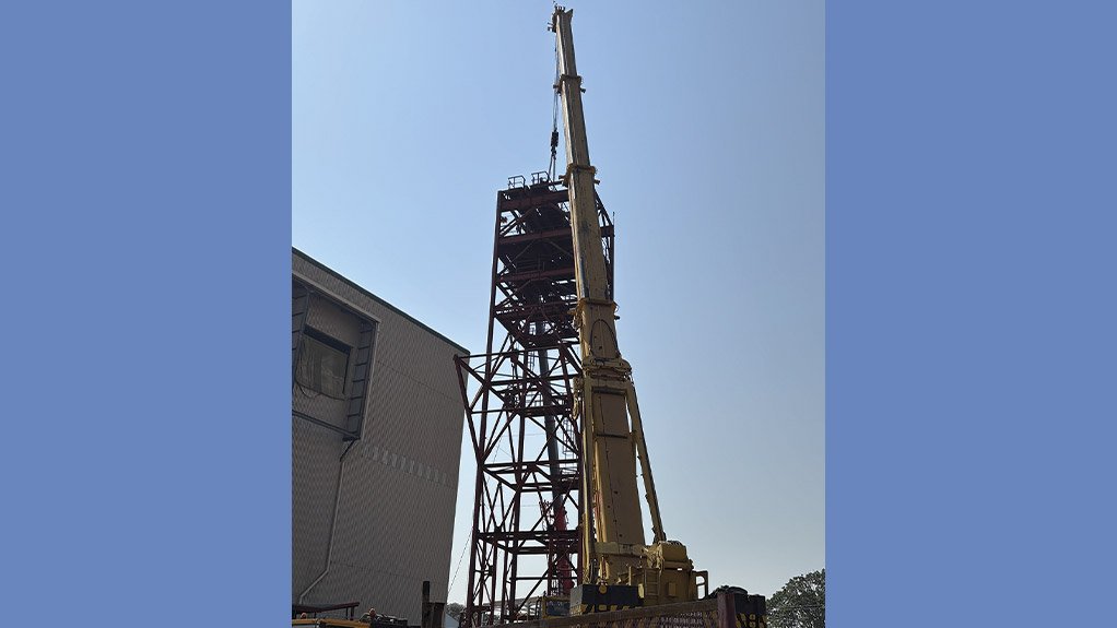 A 400 ton mobile crane assists with the dismantling of the sinking headgear during critical lifting operations