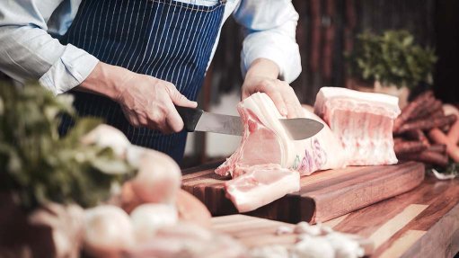 A butcher slicing meat