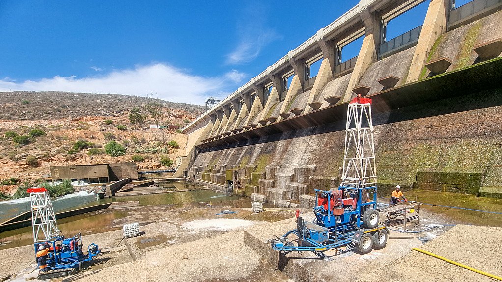 The above image depicts drill rig operators taking samples in a tailings dam