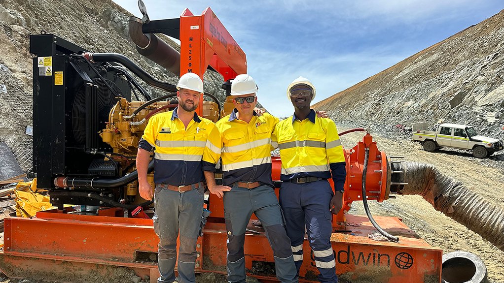 Image of 3 technicians with a Grindex pump from Integrated Pump Technology
