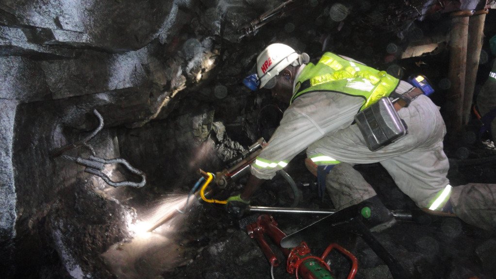 Hydro Power Equipment’s Isidingo drill and drill guide system being used by a miner in PPE