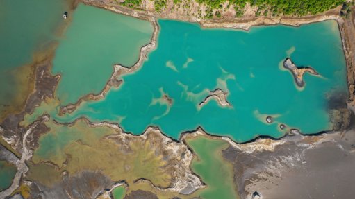 A generic image of a turquoise lake formed as a result of mining waste
