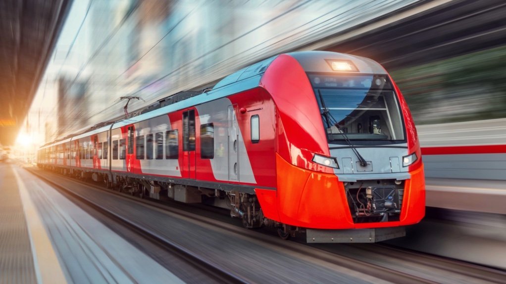 An image of a train moving on rail tracks