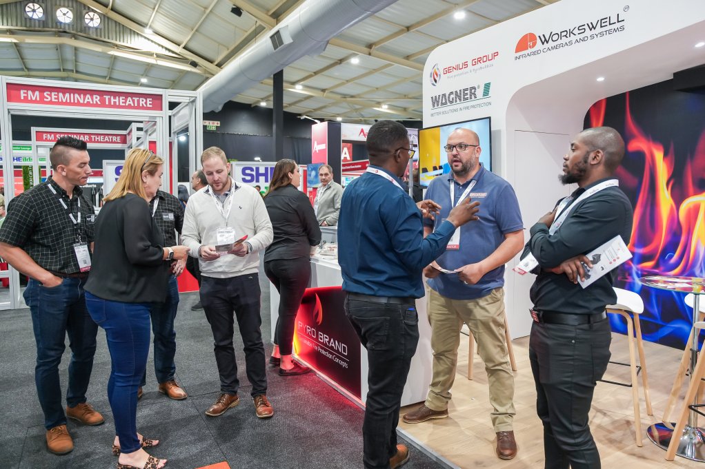 The above image depicts Firexpo visitors speaking with company representatives