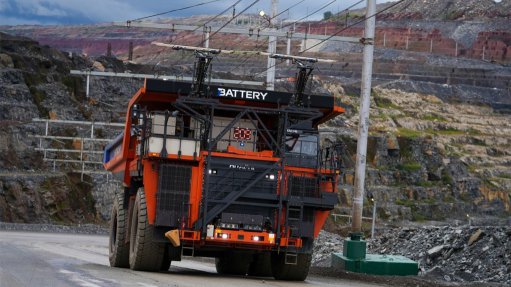A Hitachi EH 4000 AC3 battery-electric haul truck drives up an incline