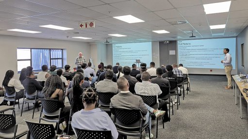 Image of delegates in a room listening to a speaker