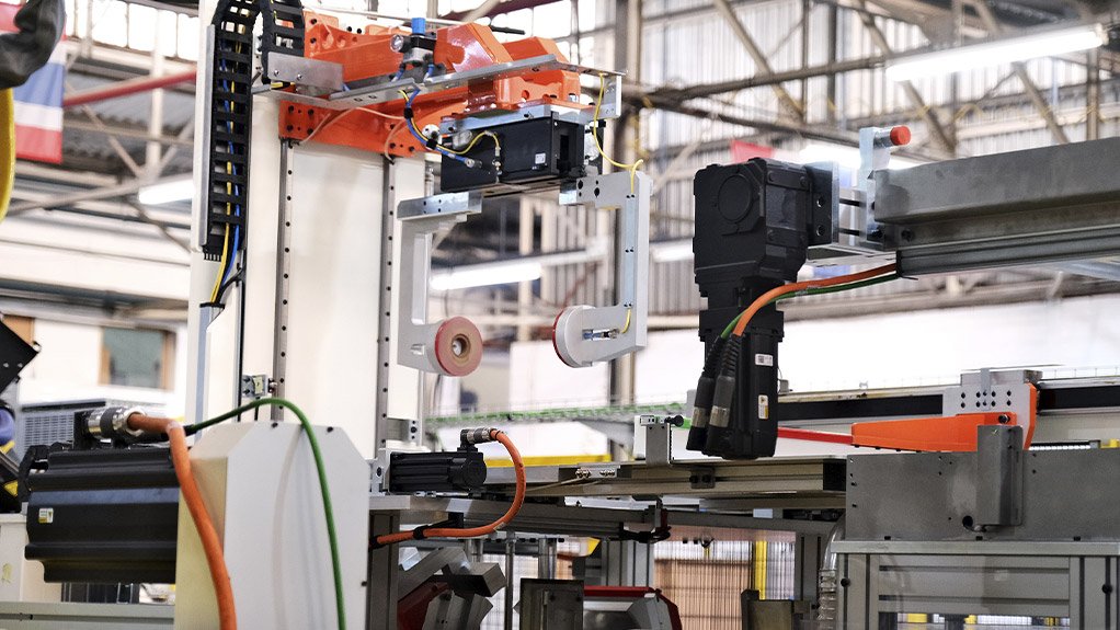 The mat gripper transfer and centralising system employs dual gripper robotics and SEW EURODRIVE servo-driven positioning to accurately align the mat within tight tolerances, ensuring precise placement before monolith insertion in a highly synchronised assembly sequence