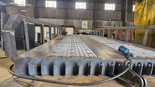 The above image depicts a scissor lift being repaired