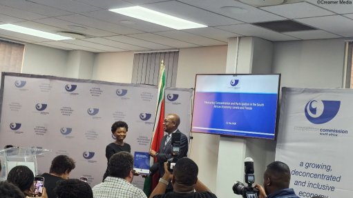 An image of Competition Commissioner Doris Tshepe handing over the report to Trade, Industry and Competition Minister Parks Tau in Pretoria 