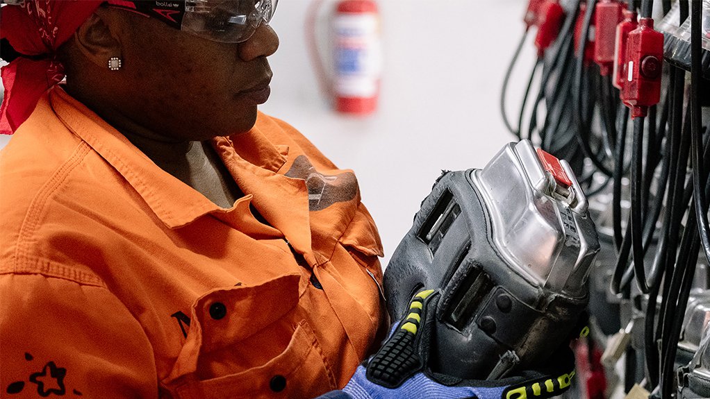 An employee gathers her rescue pack for required safety before entering Venetia Underground mine, South Africa