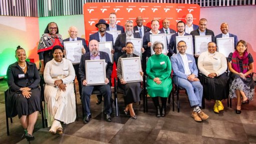 Representatives form the train operating companies hold up rail access certificates at a ceremony addressed by various Transnet executives, including CEO Michelle Phillips (seated in green). 